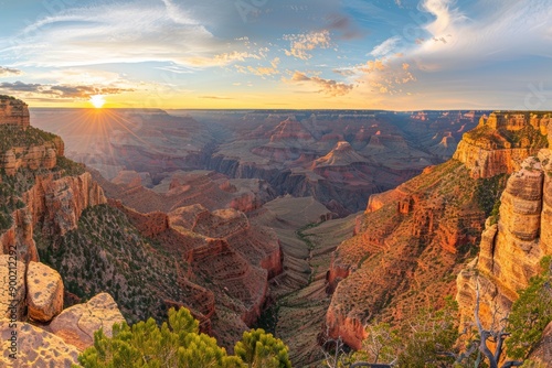 A panoramic view of the Grand Canyon, with dramatic rock formations, deep canyons, and a stunning sunrise