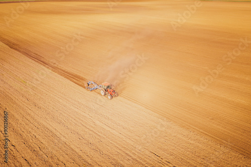 Aerial View of Farming Tractor Plowing Field for Agricultural Harvest Preparation