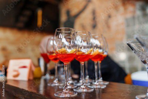 glasses of red cocktails on the bar. refreshing light alcoholic drinks for the party. aperol