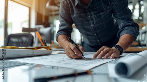 A man is writing on a piece of paper with a pen