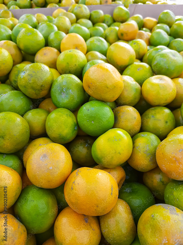 piles of oranges being sold by fruit traders piles of oranges being sold by fruit traders