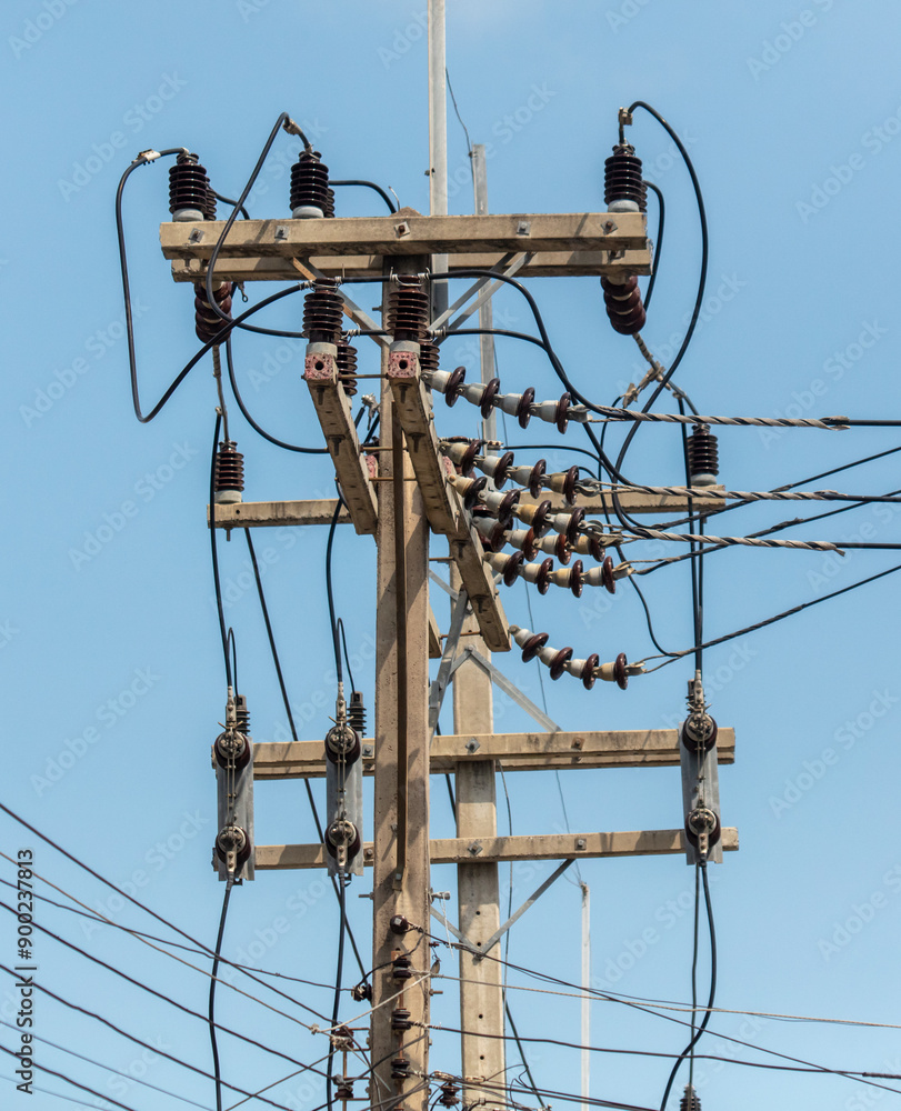 Electric wires on a pole against a blue sky Electric wires on a pole against a blue sky