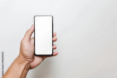 A hand holding a phone with a white screen