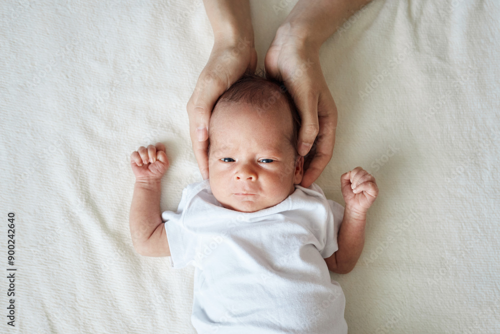 Closeup of baby's head in mother's arms lying on white blanket after having a good sleep in bed copy space for advertisement empty area for commercial content Closeup of baby's head in mother's arms lying on white blanket after having a good sleep in bed copy space for advertisement empty area for commercial content