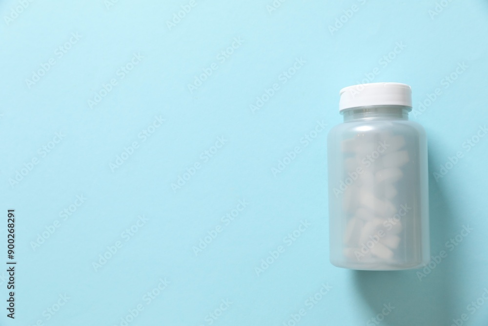 Bottle with pills on a colored background Bottle with pills on a colored background