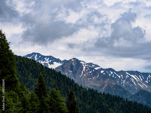 Close-up of mountain peaks adorned with snow caps, reflecting the power and beauty of the wild