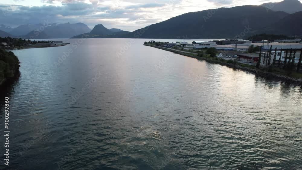 drone aerial view over golf field in andalsnes norway on a summer evening with sun and mountains in the background drone aerial view over golf field in andalsnes norway on a summer evening with sun and mountains in the background