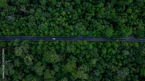 Fototapeta Naklejka Na Ścianę i Meble -  Aerial view electric vehicle car drive on asphalt road in mountain green forest, EV car electric vehicle car on forest road green energy and eco power business, EV electric car drive green forest road