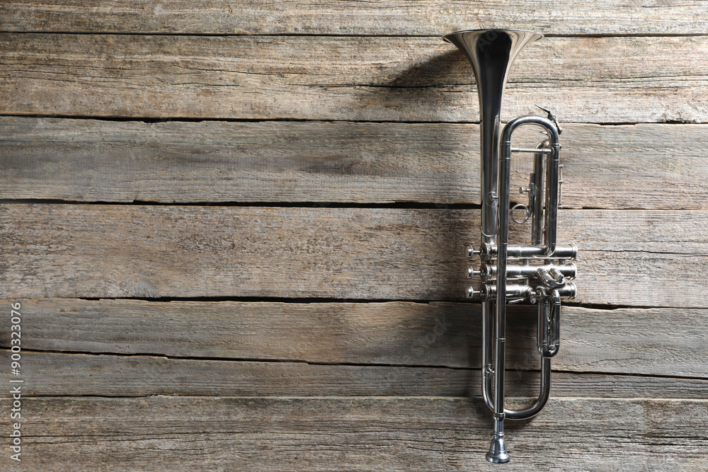 Fototapeta premium Trumpet on wooden table, top view. Space for text
