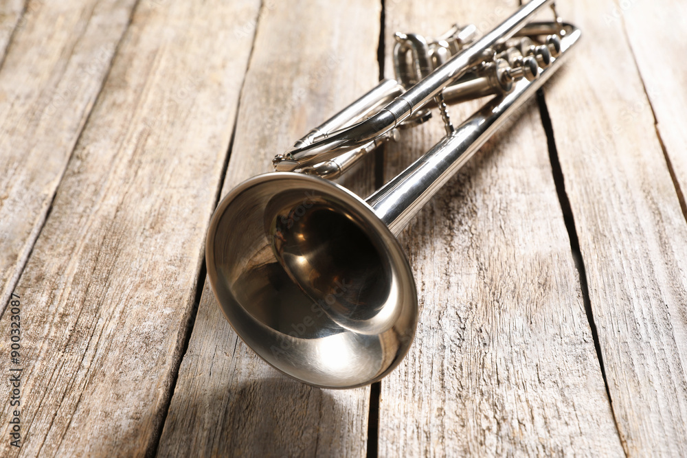 Obraz premium One trumpet on wooden table, closeup. Musical instrument