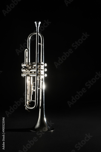 Wall Mural Shiny trumpet on black background. Wind musical instrument