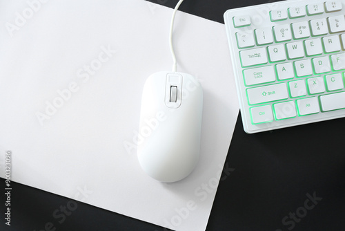 фотографія Computer mouse, mousepad and RGB keyboard on black background, top view
