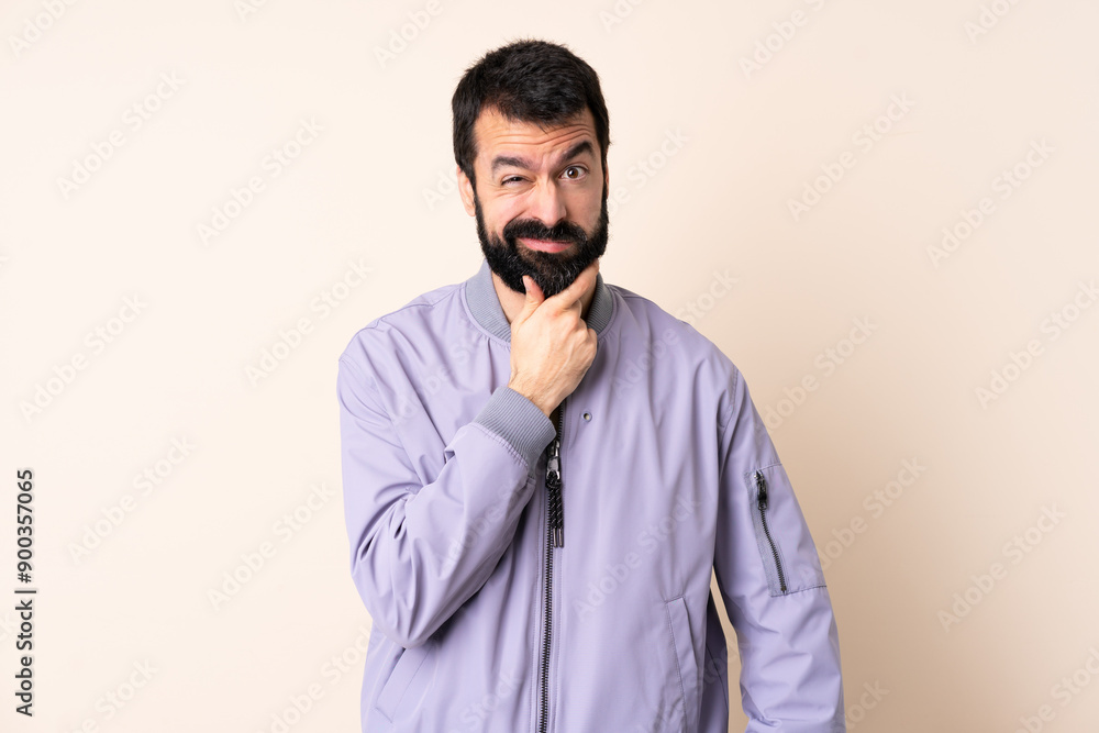 Caucasian man with beard wearing a jacket over isolated background having doubts