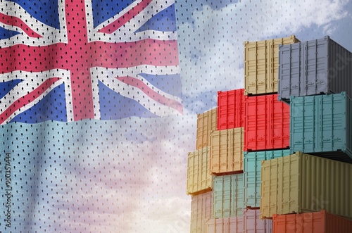 Fiji flag and big stack of shipping cargo containers in docks with sky background close up photo