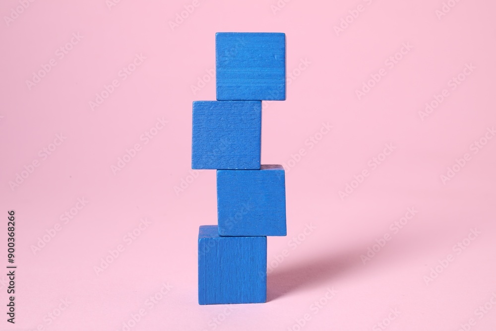 Stack of blank blue cubes on pink background Stack of blank blue cubes on pink background