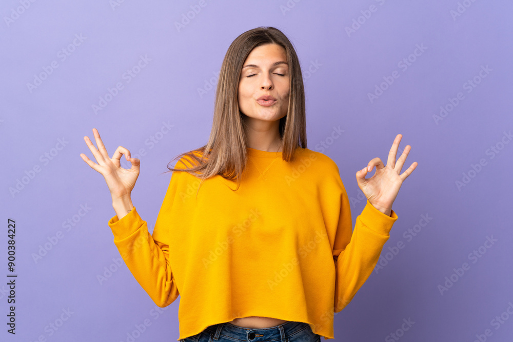 Young Slovak woman isolated on purple background in zen pose Young Slovak woman isolated on purple background in zen pose