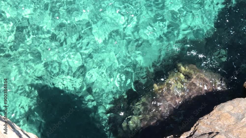 Crystal-clear Turquoise Waters Reveal The Rocky Seabed Below, Creating A Stunning Display Of Natural Beauty. The Sunlight Glistens On The Water's Surface Crystal-clear Turquoise Waters Reveal The Rocky Seabed Below, Creating A Stunning Display Of Natural Beauty. The Sunlight Glistens On The Water's Surface