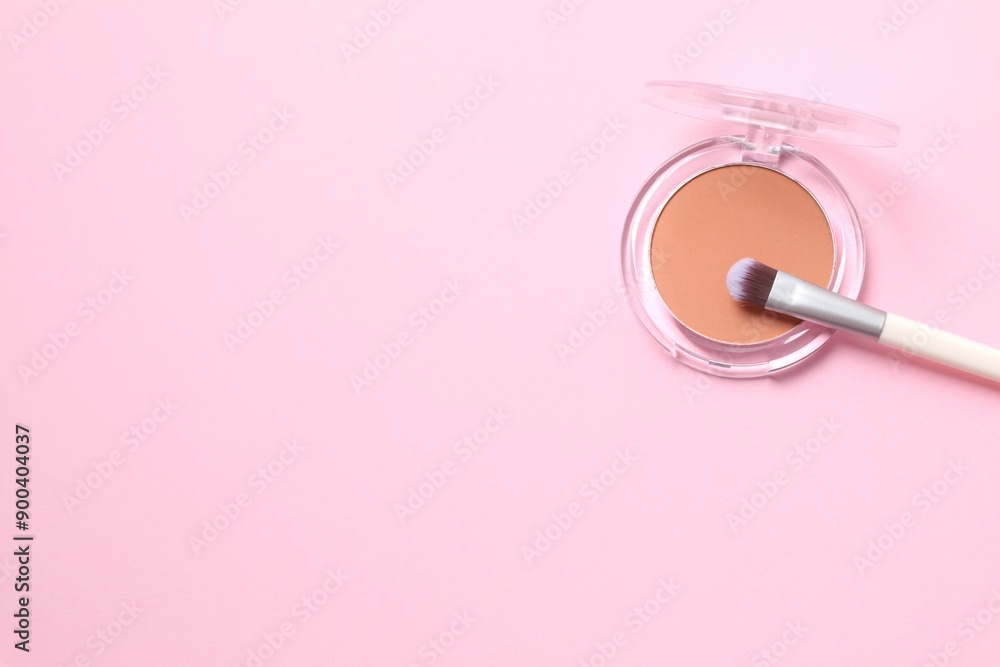 Make-up powder with a brush on a colored background Make-up powder with a brush on a colored background
