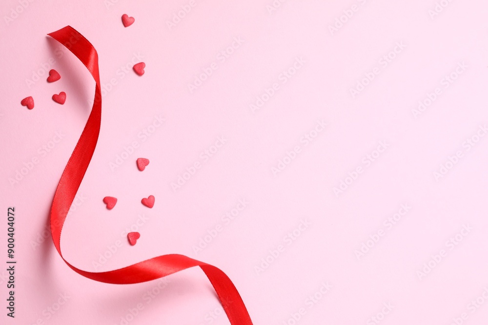 Red hearts with ribbon on color background, top view Red hearts with ribbon on color background, top view