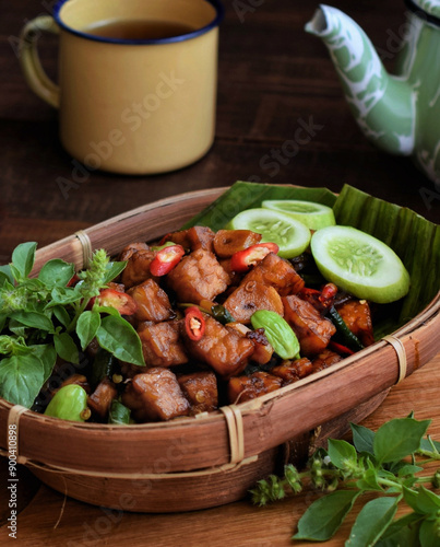 Tempe orek is a popular Indonesian dish made from sliced, fried tempeh sautéed with garlic, shallots, and sweet soy sauce, offering a savory, slightly sweet flavor. photo