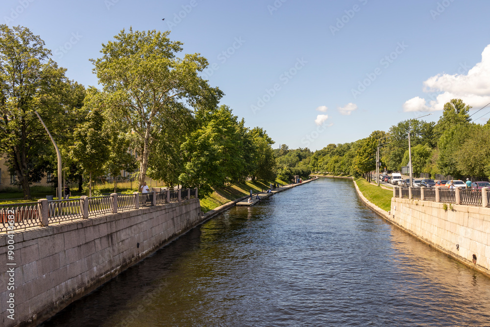 A river runs through a city with trees lining the banks A river runs through a city with trees lining the banks