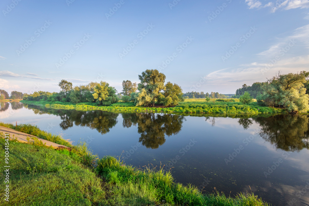 A river with trees on both sides and a clear blue sky A river with trees on both sides and a clear blue sky