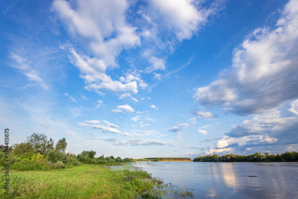 A beautiful blue sky with clouds and a river in the background A beautiful blue sky with clouds and a river in the background