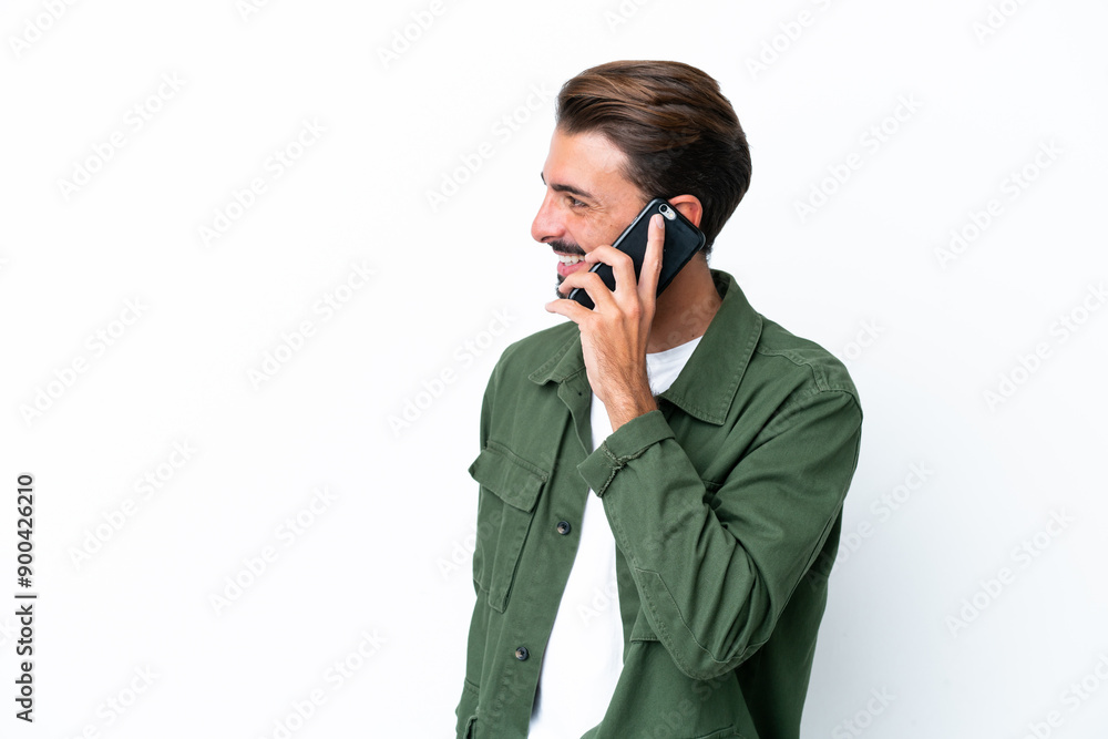 Young caucasian man isolated on white background keeping a conversation with the mobile phone with someone Young caucasian man isolated on white background keeping a conversation with the mobile phone with someone