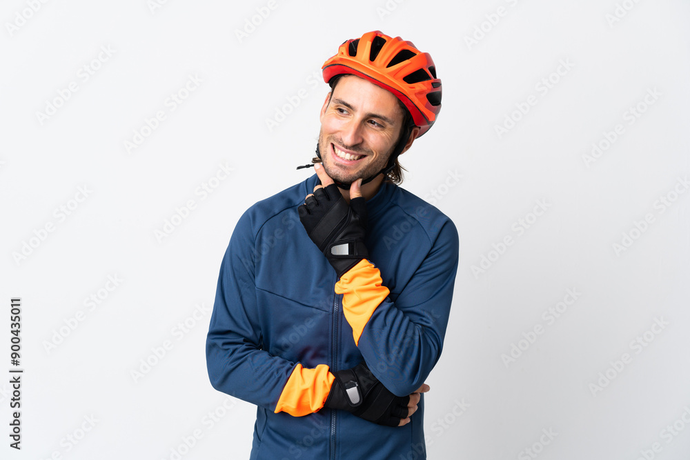 Young cyclist man isolated on white background looking to the side and smiling Young cyclist man isolated on white background looking to the side and smiling