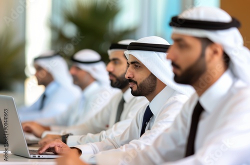 Men In Traditional Clothing Working On Laptops In Office