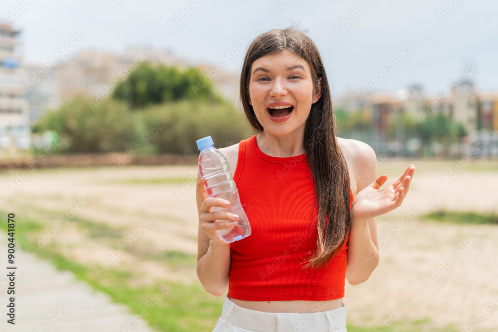 Young pretty Ukrainian woman with a bottle of water at outdoors with shocked facial expression Young pretty Ukrainian woman with a bottle of water at outdoors with shocked facial expression