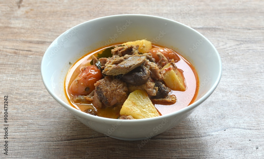 spicy boiled roasted duck meat with pineapple and tomato in coconut milk curry soup on bowl spicy boiled roasted duck meat with pineapple and tomato in coconut milk curry soup on bowl