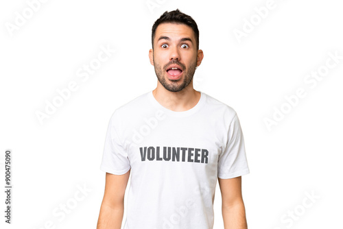 Young volunteer caucasian man over isolated chroma key background with surprise facial expression