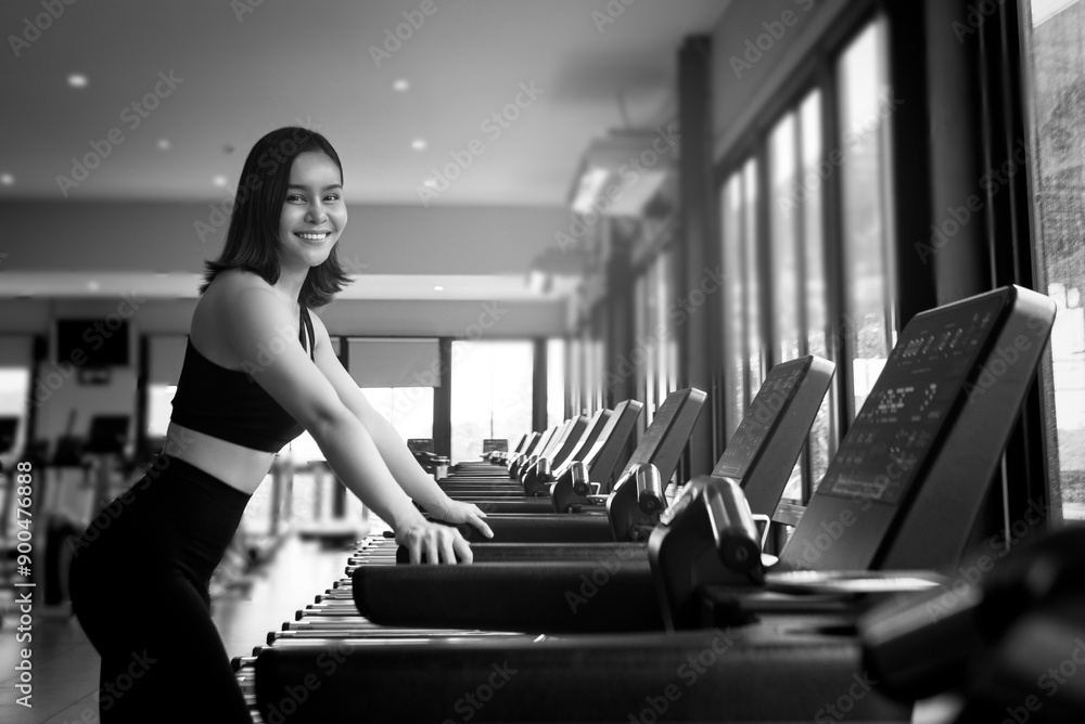 black and white photo portrait of a young woman exercise in gym, running use thereadmill machine equipment, healthy lifestyle, cardio exercise in fitness club concepts.