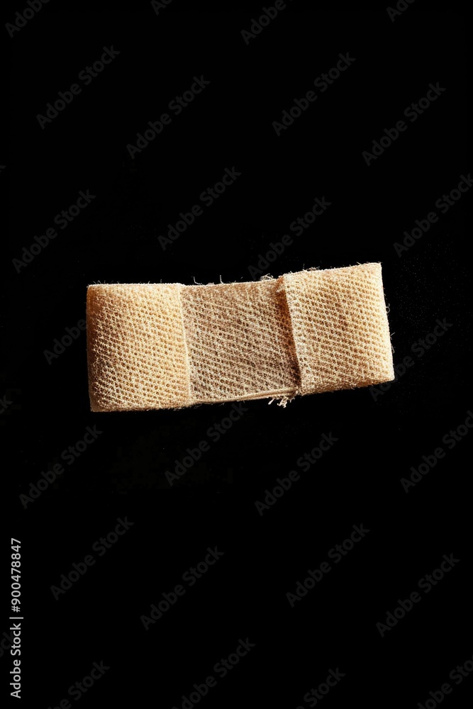 Obraz premium A piece of cloth with a piece of cloth sticking out, torn or frayed edge