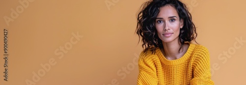 Woman in Yellow Sweater Against Orange Background