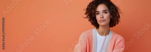 Woman in Yellow Sweater Against Orange Background