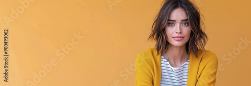 Woman in Yellow Sweater Against Orange Background
