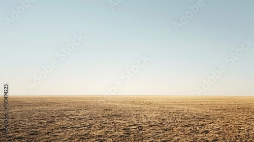 A desolate, drought-affected field under a clear sky, providing ample space for copy.