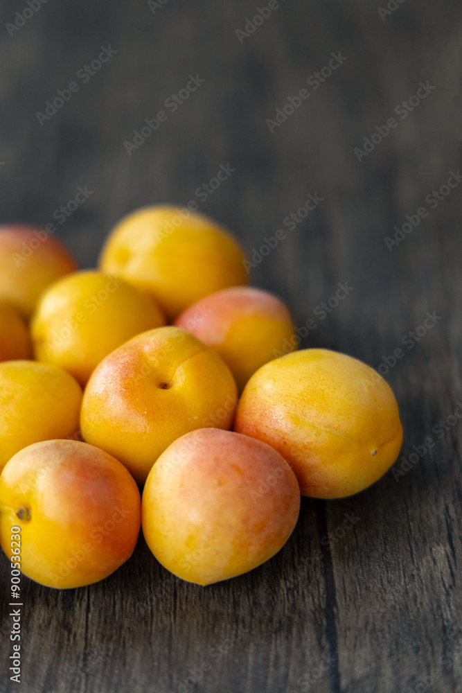 Close-up of small red apricots on wooden board, origin in Xinjiang, China Close-up of small red apricots on wooden board, origin in Xinjiang, China