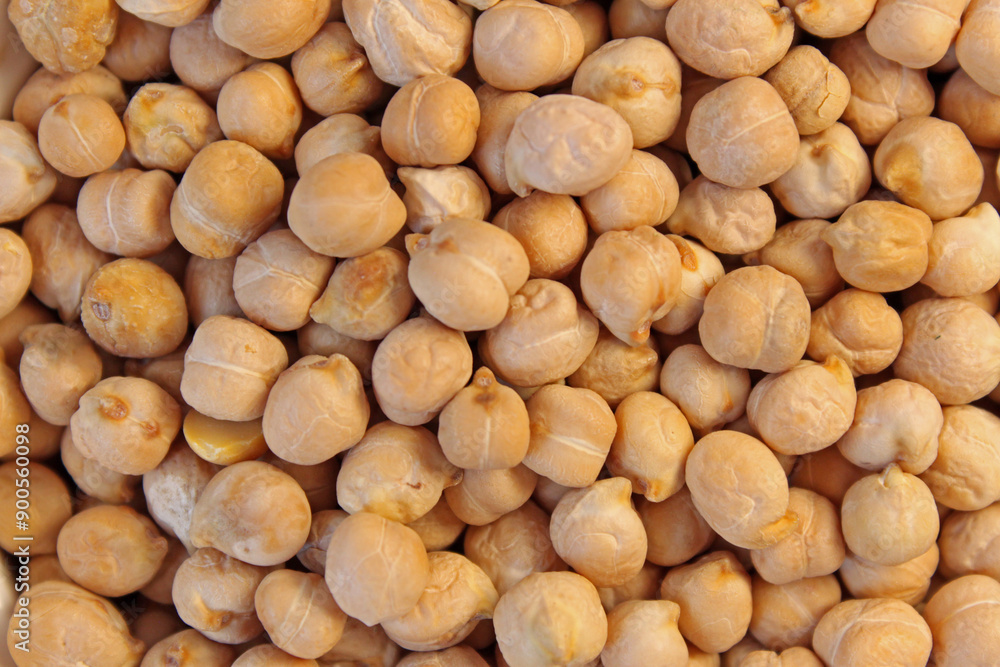 Numerous chickpeas are laying on a flat surface, creating a filled frame background texture Numerous chickpeas are laying on a flat surface, creating a filled frame background texture