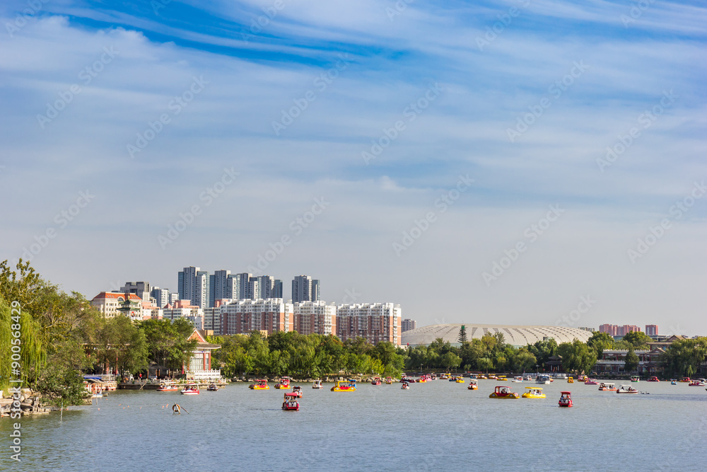 Residential buildings and Olympic Center at the lake in Shuishang Park, Tianjin, China