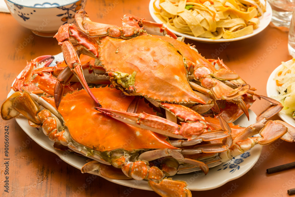 Cooked crab with chinese noodles on a wooden table