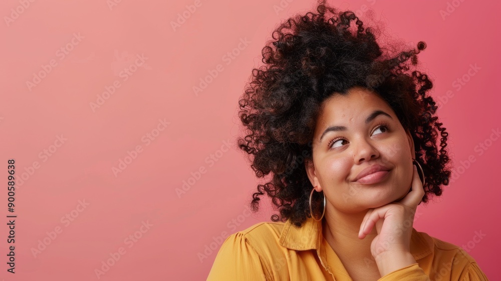 A woman with curly hair is looking up at the camera with a thoughtful expression A woman with curly hair is looking up at the camera with a thoughtful expression