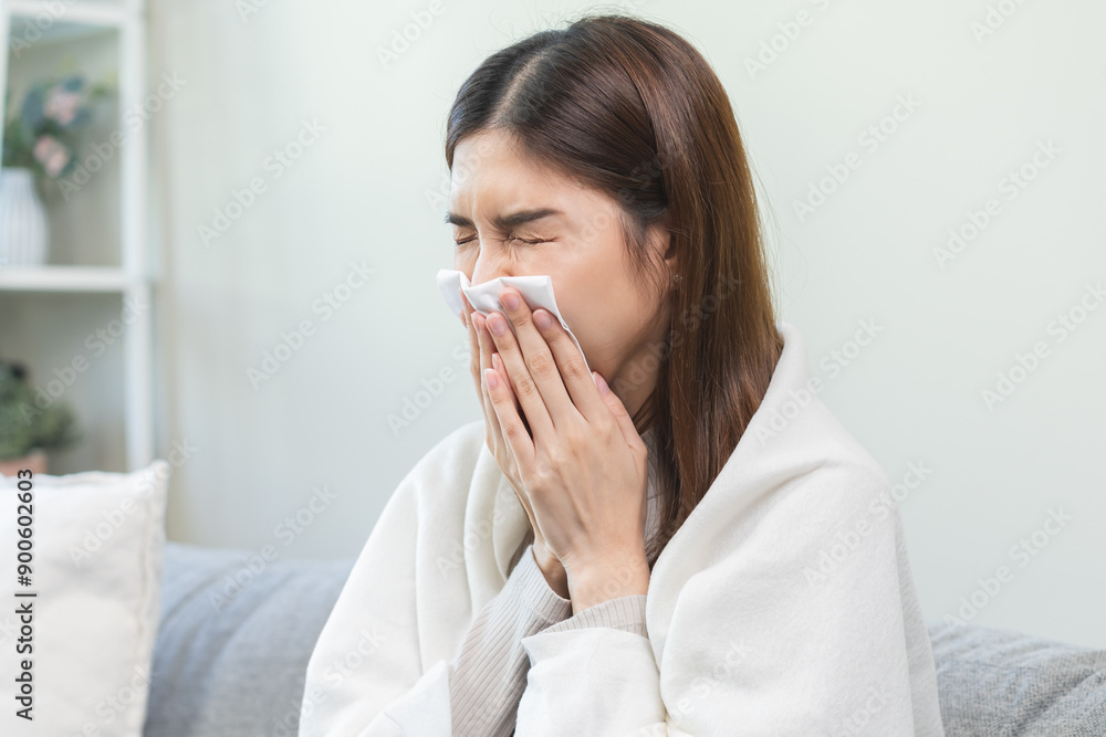Sick, coronavirus or covid, tired asian young woman have a fever, flu and hand in use tissues paper sneezing nose, runny while sitting on sofa, couch at home. Health care with disease, pandemic virus Sick, coronavirus or covid, tired asian young woman have a fever, flu and hand in use tissues paper sneezing nose, runny while sitting on sofa, couch at home. Health care with disease, pandemic virus