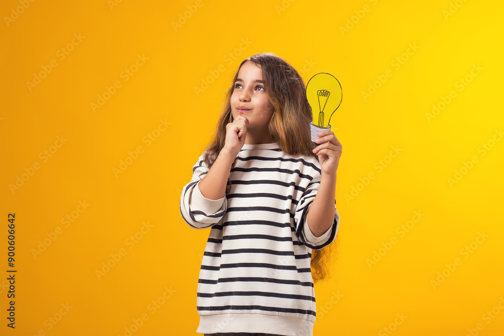 Thoughtful child girl holding paper bulb. Success, motivation, winner, genius, idea concept Thoughtful child girl holding paper bulb. Success, motivation, winner, genius, idea concept