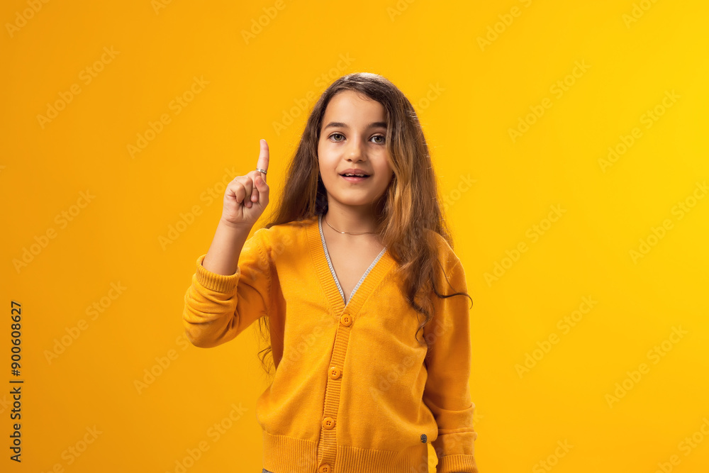 Girl pointing finger up with successful idea. Pointing at empty space. Number one. Girl pointing finger up with successful idea. Pointing at empty space. Number one.