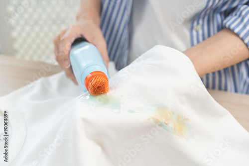 Quadro em tela Dirty stain concept, asian young housewife woman removing spill from white T-shi