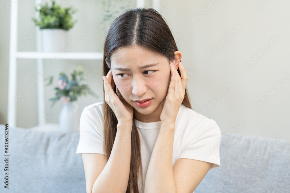 Tinnitus concept, sick asian young woman, girl have ear pain or earache, hand touch plug ear, suffering painful otitis from loud of noisy sound, inflammation. Health care nerve deaf eardrum disease. Tinnitus concept, sick asian young woman, girl have ear pain or earache, hand touch plug ear, suffering painful otitis from loud of noisy sound, inflammation. Health care nerve deaf eardrum disease.