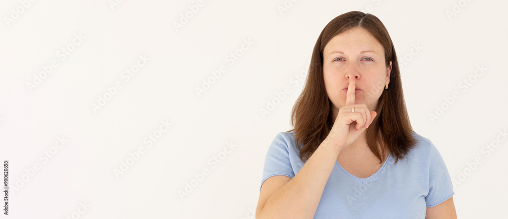 Woman ready to tell secret of beauty. Portrait of charming flirty female making shush gesture with index finger over mouth, looking sensually and confident at camera over white wall Woman ready to tell secret of beauty. Portrait of charming flirty female making shush gesture with index finger over mouth, looking sensually and confident at camera over white wall